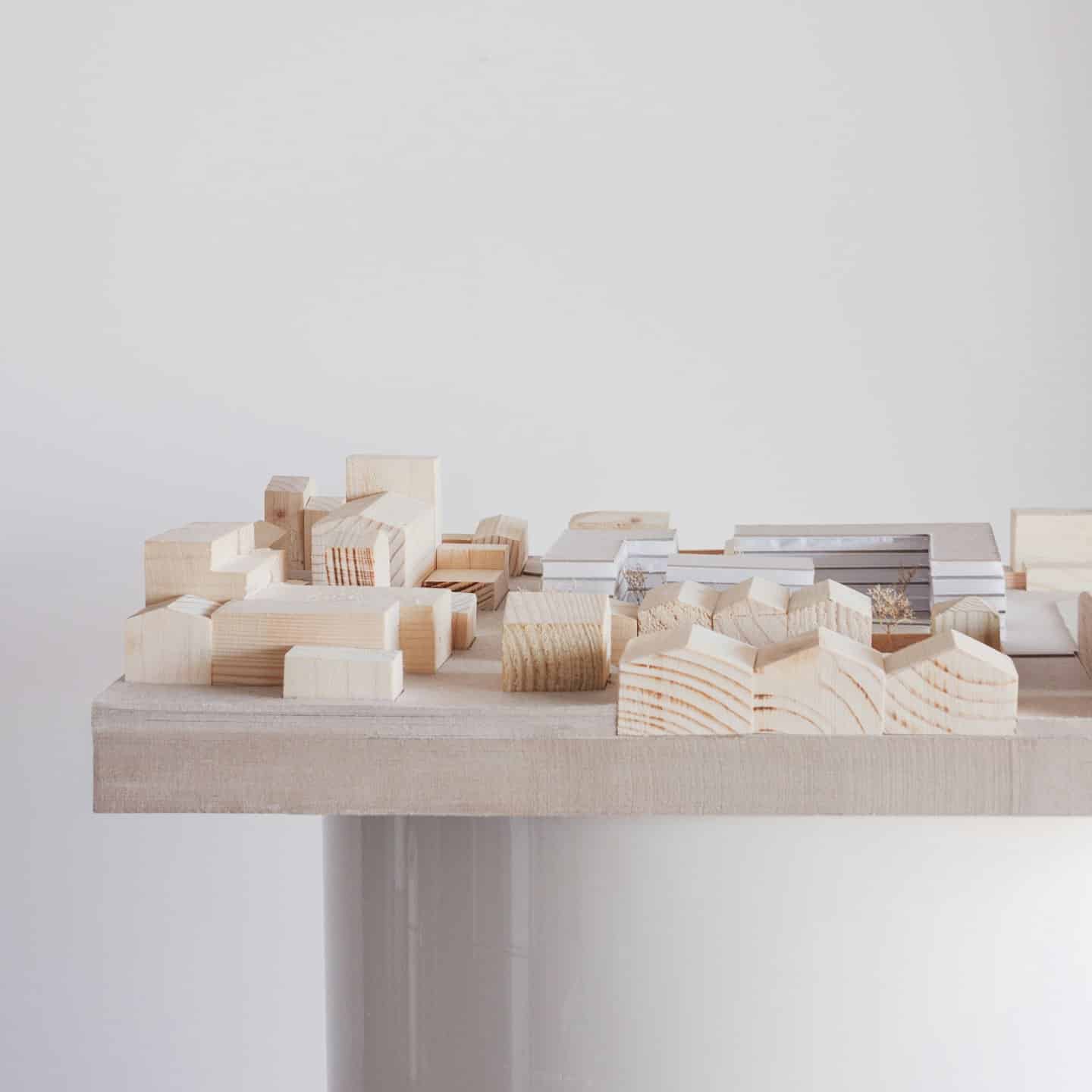 Wooden architectural model of a city with buildings.